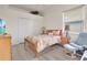 Cozy bedroom with light wood floors and a comfortable seating area at 5944 Lake Melrose Dr, Orlando, FL 32829