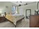 Comfortable bedroom with light green walls and neutral-colored furniture at 5944 Lake Melrose Dr, Orlando, FL 32829