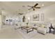 Open-concept living room with light colored walls, tiled floor, and a direct view of the kitchen at 5944 Lake Melrose Dr, Orlando, FL 32829