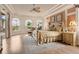 Main bedroom suite boasts a tray ceiling, a ceiling fan and multiple windows at 5944 Lake Melrose Dr, Orlando, FL 32829