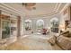 Comfortable main bedroom featuring tray ceilings, lots of natural light, and access to a patio and pool area at 5944 Lake Melrose Dr, Orlando, FL 32829