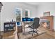 Well-lit office space featuring a fireplace and large windows with a view at 5944 Lake Melrose Dr, Orlando, FL 32829