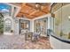 Outdoor covered patio with seating area, grill, and a view of the backyard at 5944 Lake Melrose Dr, Orlando, FL 32829