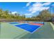 A vibrant pickleball court is shown with a blue, green, and red surface at 5944 Lake Melrose Dr, Orlando, FL 32829