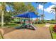 A colorful playground with a slide and shaded area sits amidst lush landscaping and palm trees at 5944 Lake Melrose Dr, Orlando, FL 32829