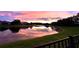 Colorful sunset reflecting in a peaceful pond, showcasing the beautiful community setting at 5944 Lake Melrose Dr, Orlando, FL 32829