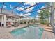 Beautiful pool area with a built-in grill, patio seating, and lake view at 5944 Lake Melrose Dr, Orlando, FL 32829