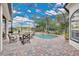 Relaxing screened-in pool area with comfortable seating and lush landscaping at 5944 Lake Melrose Dr, Orlando, FL 32829