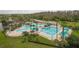 Aerial view of the community pool with large lap pool, splashpad, and palm tree landscaping at 5944 Lake Melrose Dr, Orlando, FL 32829
