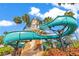 A turquoise water slide wraps around a lighthouse structure near a pool and tropical vegetation at 5944 Lake Melrose Dr, Orlando, FL 32829