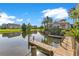 A waterfront view with a wooden dock, serene lake, and inviting community buildings at 5944 Lake Melrose Dr, Orlando, FL 32829