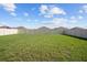 Wide backyard featuring lush green grass and a white fence at 601 Watusi Way, St Cloud, FL 34772