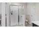 Modern bathroom features a glass-enclosed shower, toilet, and white walls at 601 Watusi Way, St Cloud, FL 34772