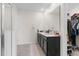 Bright bathroom with double sinks, modern fixtures, and a walk-in shower at 601 Watusi Way, St Cloud, FL 34772