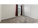 Cozy bedroom showcasing window with dark-red curtains and a closet at 601 Watusi Way, St Cloud, FL 34772