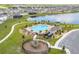 Aerial view of community pool and playground including a view of the lake at 601 Watusi Way, St Cloud, FL 34772