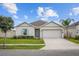 Charming single-story home with a two-car garage, well-maintained lawn, and appealing curb appeal at 601 Watusi Way, St Cloud, FL 34772