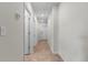 Well-lit hallway featuring neutral paint, tile floor, and white doors at 601 Watusi Way, St Cloud, FL 34772