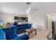 Bright living space with modern furnishings including two blue couches and open access to the kitchen at 601 Watusi Way, St Cloud, FL 34772