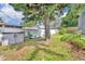 Backyard features a storage shed, lush green grass, mature trees, and a white fence, ideal for outdoor activities at 604 Ponca Trl, Maitland, FL 32751