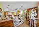 Open-concept living and dining area with hardwood floors, charming decor, and ample natural light at 604 Ponca Trl, Maitland, FL 32751
