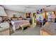Comfortable bedroom featuring floral wallpaper, a ceiling fan, and a walk-in closet for ample storage at 604 Ponca Trl, Maitland, FL 32751