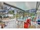 Screened in lanai featuring a pool, hot tub, statues, and an outdoor dining area with seating and a decorative fountain at 604 Ponca Trl, Maitland, FL 32751