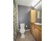 Functional bathroom with a toilet, vanity with granite counter, and shower with floral curtain at 610 Heatherton Vlg # 610, Altamonte Springs, FL 32714