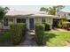 Charming single-story home featuring well-maintained landscaping and a quaint blue front door at 610 Heatherton Vlg # 610, Altamonte Springs, FL 32714