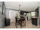 Cozy kitchen area with dark cabinets, tile flooring, and access to outdoor space through sliding doors at 610 Heatherton Vlg # 610, Altamonte Springs, FL 32714