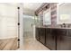 Bathroom with wood accent wall, glass shower, double vanity, and walk-in closet at 7184 Enchanted Lake Dr, Winter Garden, FL 34787