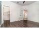 Bedroom showcasing wood floors, a ceiling fan, and a closet, with a view of a staircase at 7184 Enchanted Lake Dr, Winter Garden, FL 34787