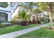 Street view of home with well-kept lawn and landscaped garden at 7184 Enchanted Lake Dr, Winter Garden, FL 34787