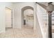 Bright foyer with tile flooring, archway and view of staircase at 7184 Enchanted Lake Dr, Winter Garden, FL 34787