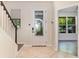 Bright foyer with tile flooring, decorative door and staircase at 7184 Enchanted Lake Dr, Winter Garden, FL 34787