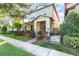 View of a well maintained two-story home with a landscaped yard and walkway at 7184 Enchanted Lake Dr, Winter Garden, FL 34787