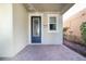 Inviting front porch with brick pavers, decorative door and window at 7184 Enchanted Lake Dr, Winter Garden, FL 34787