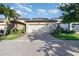 This house features a two-car garage with brick paver driveway and manicured landscaping at 7184 Enchanted Lake Dr, Winter Garden, FL 34787