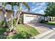 Garage with a paved driveway and manicured landscaping at 7184 Enchanted Lake Dr, Winter Garden, FL 34787
