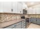 This kitchen features granite countertops, stainless steel appliances, and bright white cabinets with modern hardware at 7184 Enchanted Lake Dr, Winter Garden, FL 34787