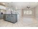 Spacious open-concept kitchen area with a large island, modern lighting, stainless steel appliances, and tile flooring at 7184 Enchanted Lake Dr, Winter Garden, FL 34787