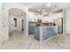 Modern kitchen with white cabinets, stainless steel appliances and large island at 7184 Enchanted Lake Dr, Winter Garden, FL 34787