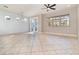 Spacious and bright living room with tile floors, large windows and a ceiling fan at 7184 Enchanted Lake Dr, Winter Garden, FL 34787