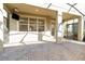 Enclosed brick patio with television and view of interior kitchen at 7184 Enchanted Lake Dr, Winter Garden, FL 34787