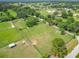Aerial image showcasing a vast horse property with well-maintained pastures, barns and ample space for equestrian activities at 750 Sw 91St Pl, Ocala, FL 34476