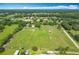 Aerial shot of a horse farm featuring extensive pastures, barns, and scenic rural views at 750 Sw 91St Pl, Ocala, FL 34476