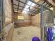 Interior shot of horse stall with wood frame, metal bars, and straw covering the ground at 750 Sw 91St Pl, Ocala, FL 34476