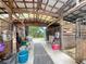 Interior view of a barn featuring multiple stalls, equipment, and ceiling fans at 750 Sw 91St Pl, Ocala, FL 34476