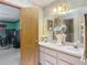 A spacious bathroom with double sinks and vanity and wallpaper decor at 750 Sw 91St Pl, Ocala, FL 34476