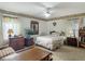 A comfortable bedroom with a ceiling fan and vintage decor at 750 Sw 91St Pl, Ocala, FL 34476